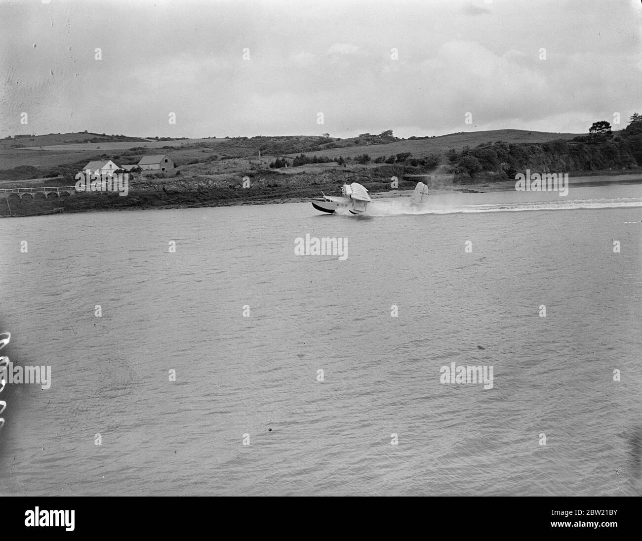 The Clipper landing on sea. Comander, Captain Harold E Gray and members of they crew of the clipper. as it landed at Foynes air base after a historic flight in 12 hours and 40 minutes. In which the British flying boat inaugurated the transatlantic 's experimental service. 6 July 1937 Stock Photo