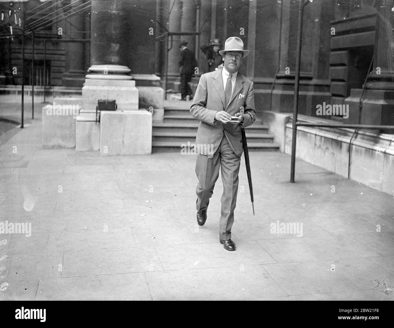 Mr R. G. Howe leaving the Foreign Office after his call. He is to make an air dash to China to take over the duties of Sir Hughe Knatchbull-Hugessen, shot British Ambassador. Mr R. Mr R. G. Howe was called at the Foreign Office to receive final instructions before leaving. Mr Howe was councillor at the Nanking Embassy [Nanjing] from May 1934 onwards. He will leave almost at once for China to resume his old duties to act as Charge d'Affaires in the emergency. Mr Howe is one of the few members of the diplomatic service to have attended elementary school. 28 August 1937 Stock Photo