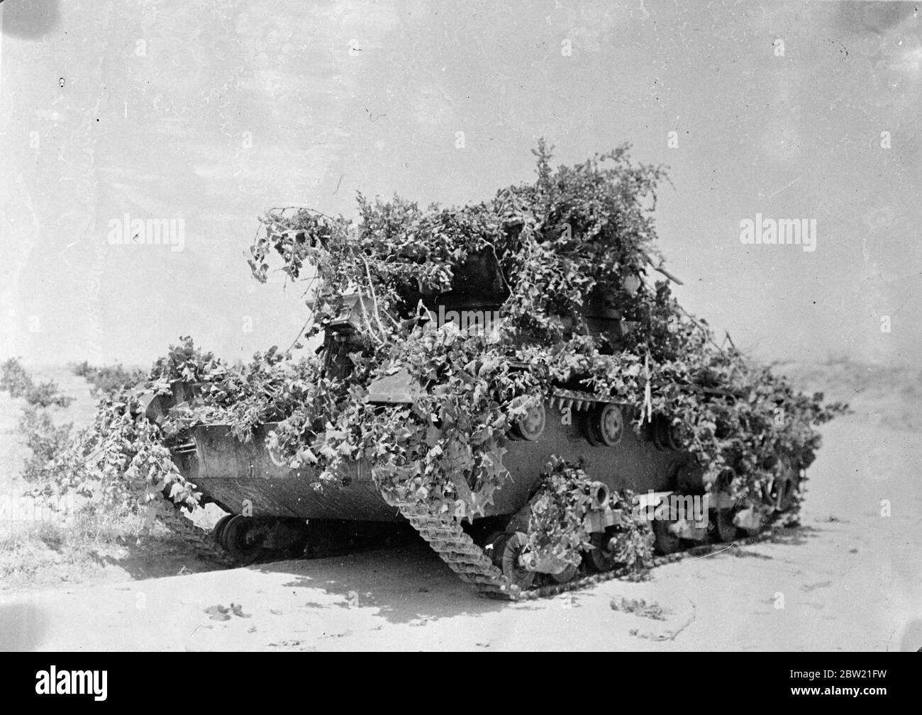 Heavy tank camouflaged with grass and branches of trees, that was captured by the rebels from the government forces during the fierce battle which marked renewed activity on the Madrid front. 13 August 1937. Stock Photo