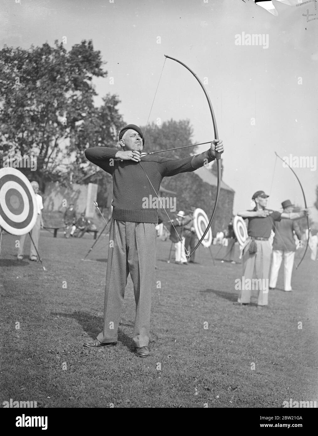 That archery is returning to popularity is indicated by the record number of entries in the Southern Counties Championships which has opened at the Imperial Services College, Windsor. Mr J. Weston Martyrn, well-known author of sea stories, taking aim. 31 August 1937 Stock Photo