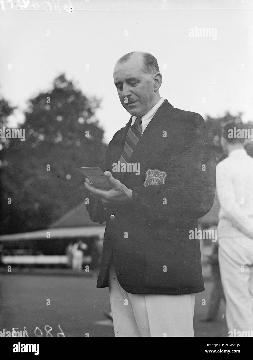 Mr J Watson, M.C a choriater in St George's Chapel altering the scoreboard at the Royal household Bowling club of Windsor Castle, membership of which is confined to persons in the Royal services. They played a match against the Australian team in the grounds of Windsor Castle. During their visit members of the Australian team had tea at the castle and were shown around the state apartments. 5 September 1937. Stock Photo