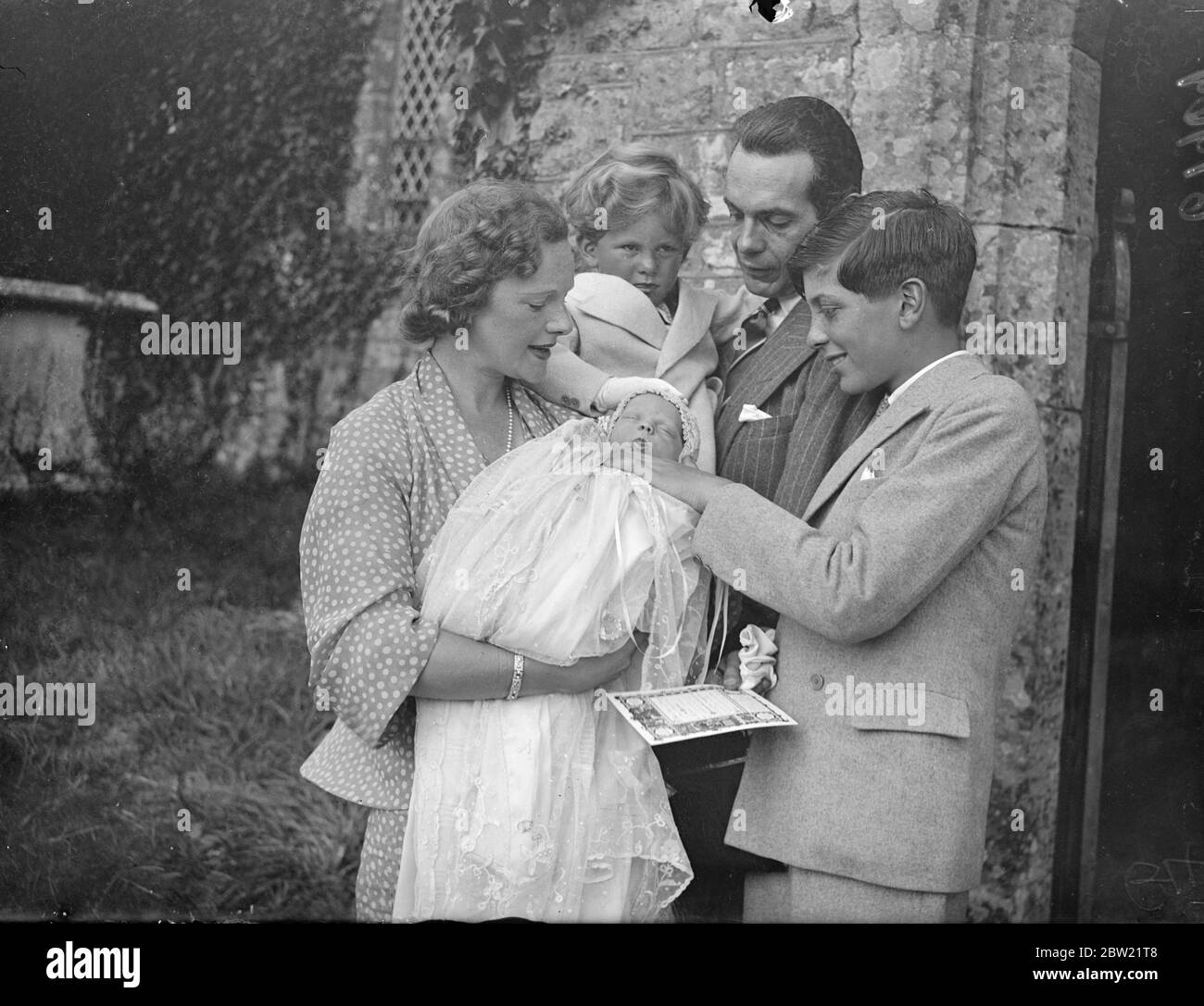The actor Raymond Massey and his wife Adrienne Allen, with the baby, Anna and their two sons Daniel and Geoffrey (right) after the christening at Thakeham, Sussex. 3 September 1937 Stock Photo
