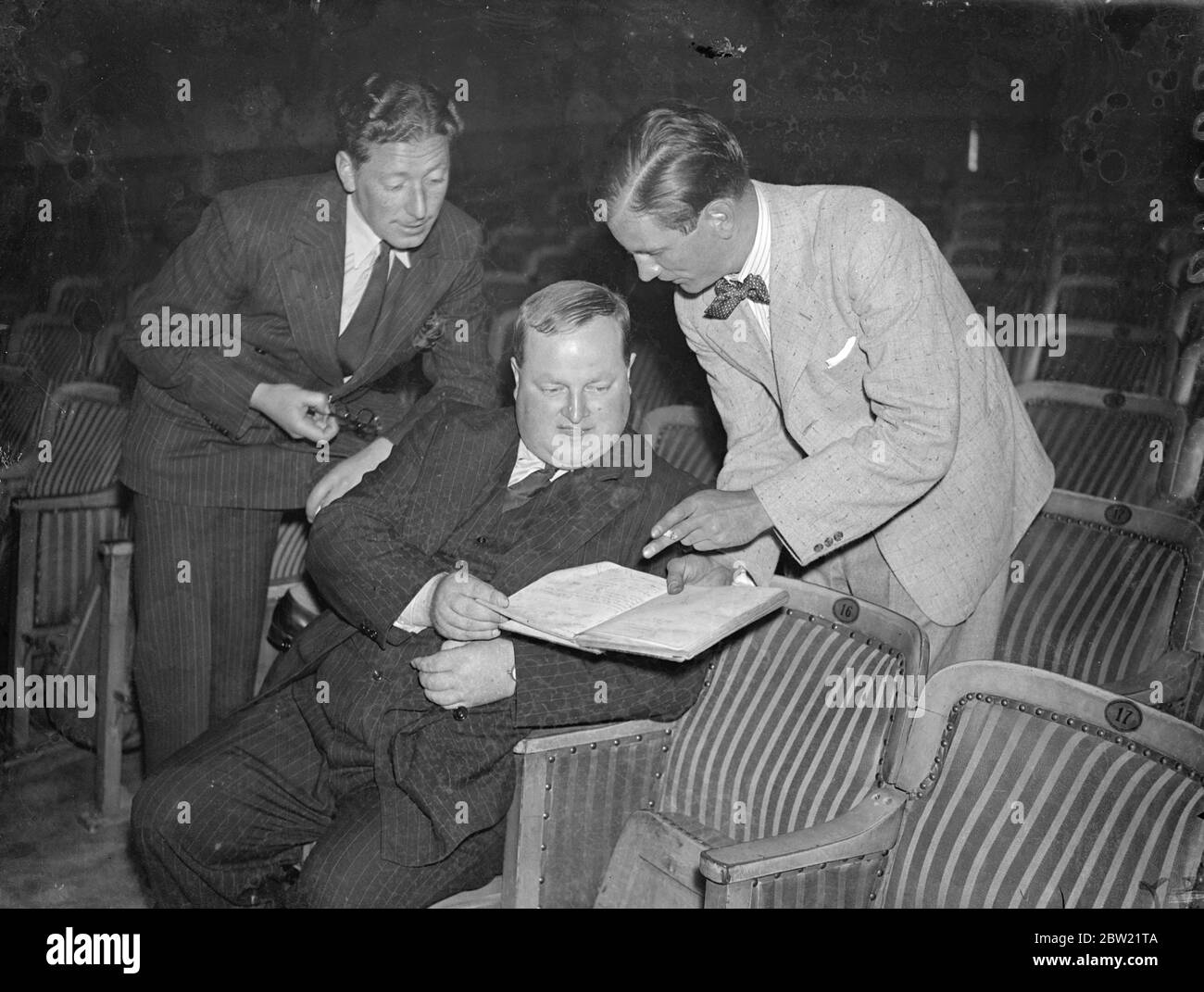 The Earl of Longford (centre) going over the script of Camilla with Peter Powell, the producer (right) and Henry fine, the manager of the Westminster Theatre. The play will open September 9 at the start of the season of new Irish plays performed by Lord Longford's company from the doubling gate theatre. 4 September 1937. Stock Photo