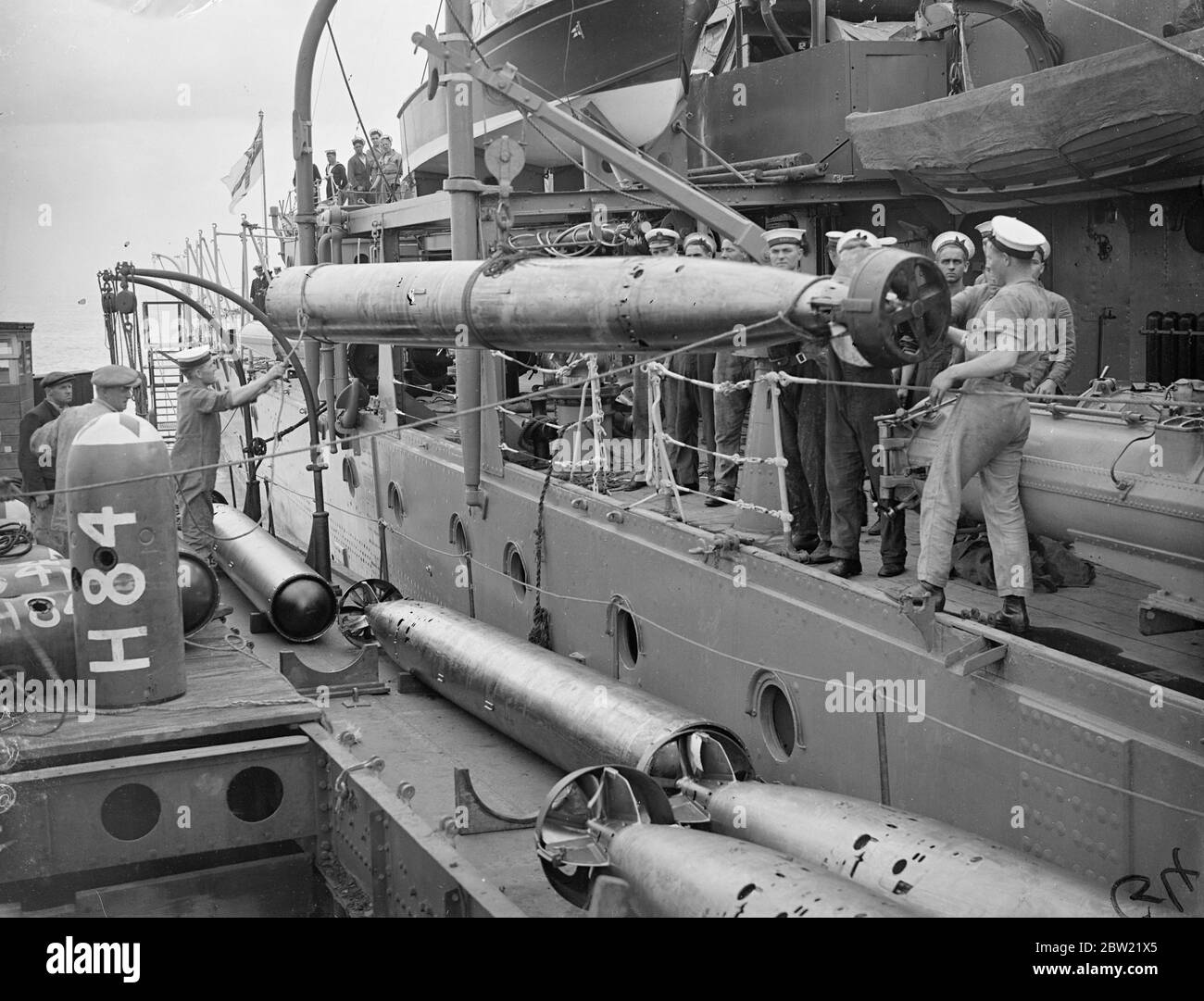 Torpedoes being taken aboard H.M.S Cairo at Sheerness. The ship is getting ready to leave for the Mediterranean where she will join the antipiracy patrol devised at the N conference. Also leaving for the Mediterranean is the fourth destroyer Flotilla comprising of nine warships. 16 September 1937. Stock Photo