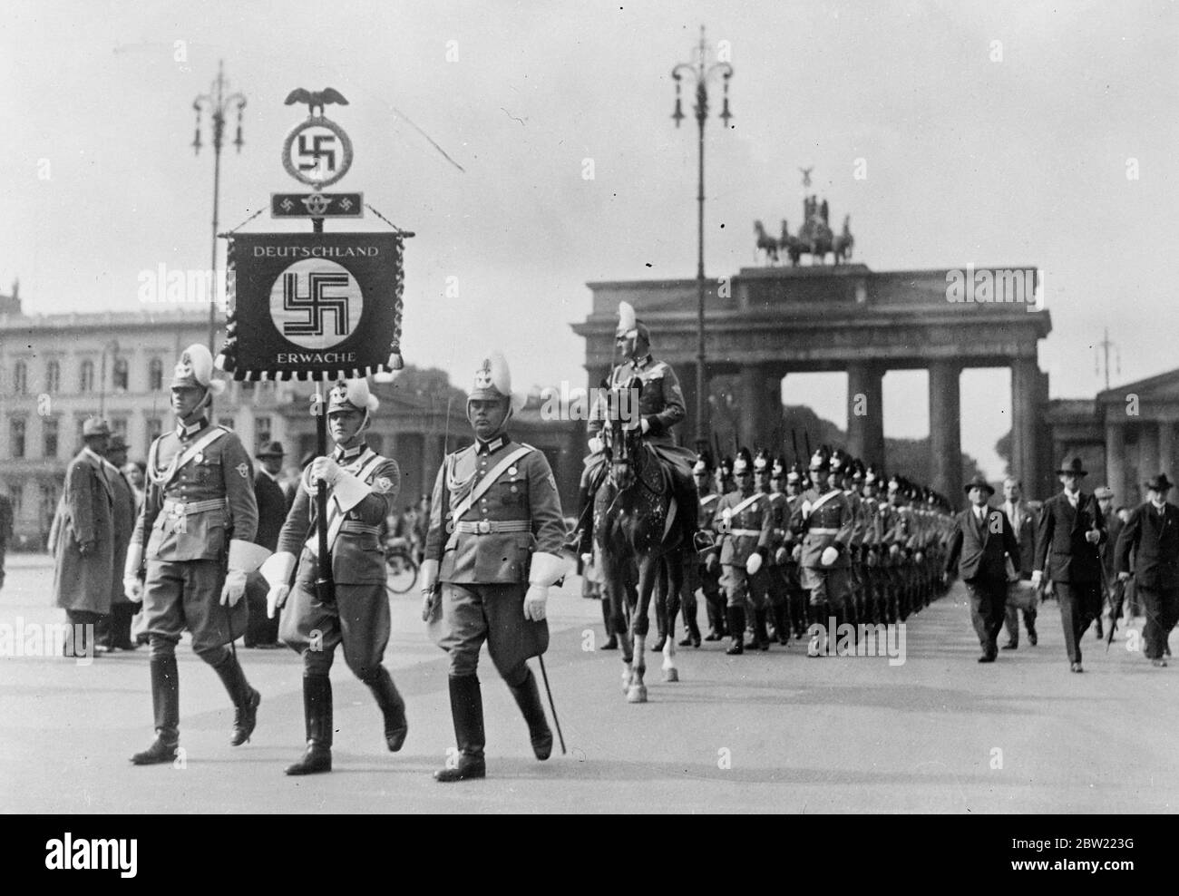 The police with the new standard at their head, marching through the Brandemburg Gate, Berlin. Smartly uniformed German police marched through Berlin, the new standard was presented to them by Herr Hitler himself. 16 September 1937. Stock Photo