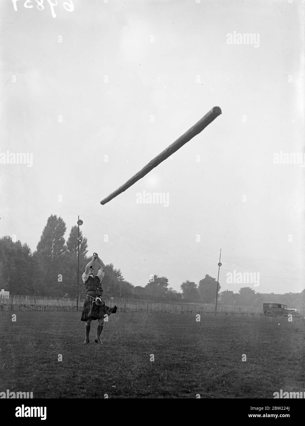 Pipers and kilted clans men invaded Ranelegh club, advanced to compete in the first Highland gathering held in London for many years. Picture shows, Mr A.B Weir, for three years all-round champion at cowal Games tossing the caber. 29 September 1937. Stock Photo