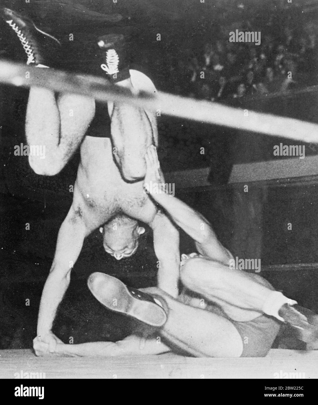 Ignacio Martinez dives head first at the prostrate Pat Meehan during their wresting bout at the coliseum in Los Angeles Califronia. 7 October 1937.[?] Stock Photo