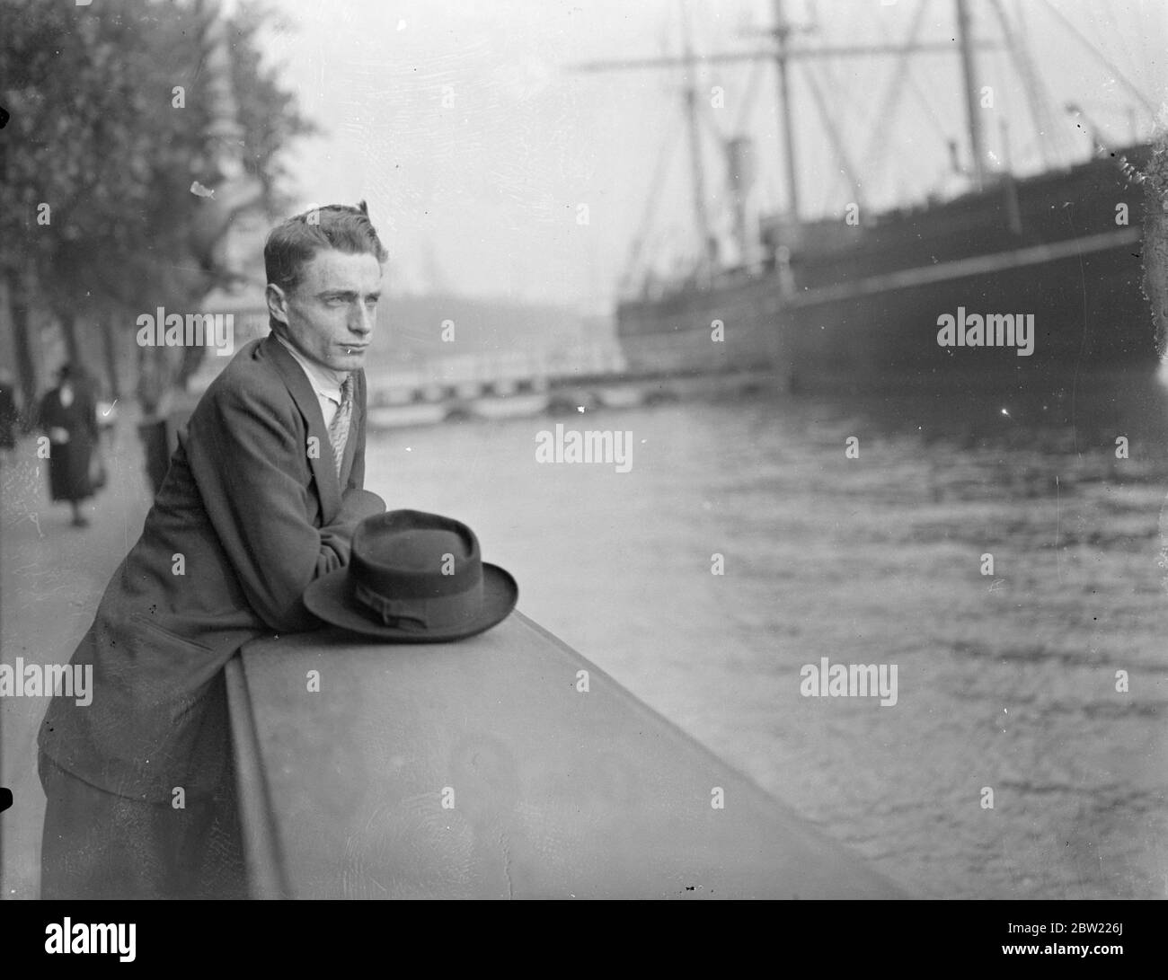 Mr Philip Knowling gazing out over the Thames from the embankment on his arrival in London. The son-in-law of Mr Lloyd George and nephew of Sir Thomas Carey-Evans, the surgeon, has arrived in London, after wandering round the world, as Coal-trimmer, seal fisher and stevedore. Urged by the desire to see conditions in Russia for himself, he went from Toronto to Hull, hitchhiked to London and managed to get a passage to Russia. From there he visited Hashed, Holy City of the Persians and went on to India and Burma, where he slept in monasteries. He cycled through Burma to Siam and going through to Stock Photo