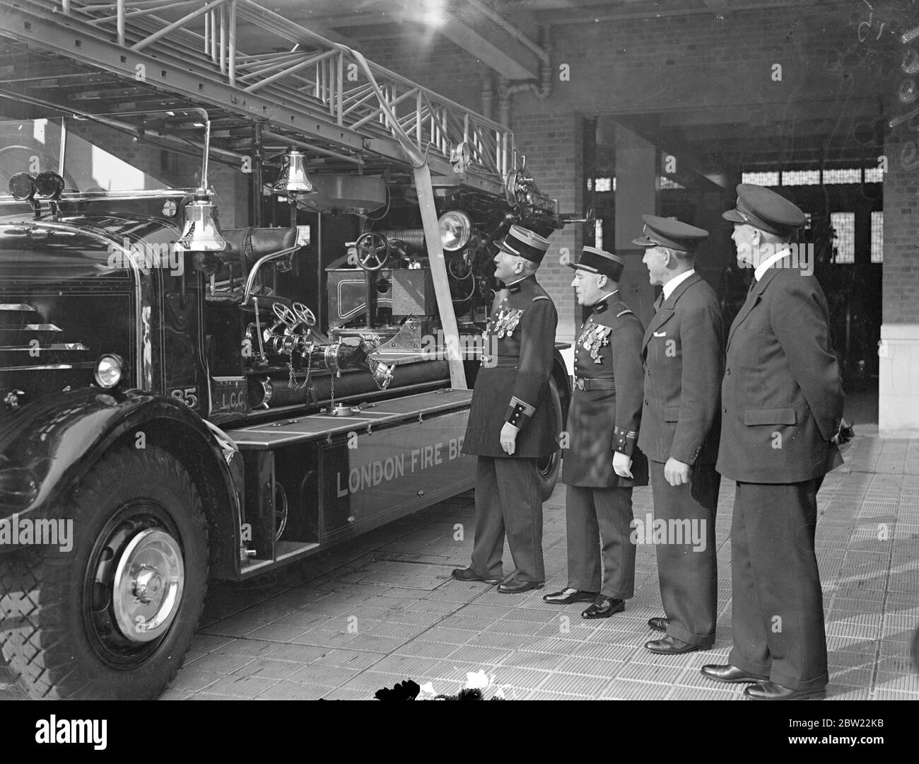 Colonel Islert, chief of the Paris Fire Brigade, inspecting a fire engine. Who is visiting London to inspect British fire-fighting methods and apparatus, made a tour of inspection at the London Fire Brigade Headquarters on the Albert Embankment. 24 September 1937. Stock Photo