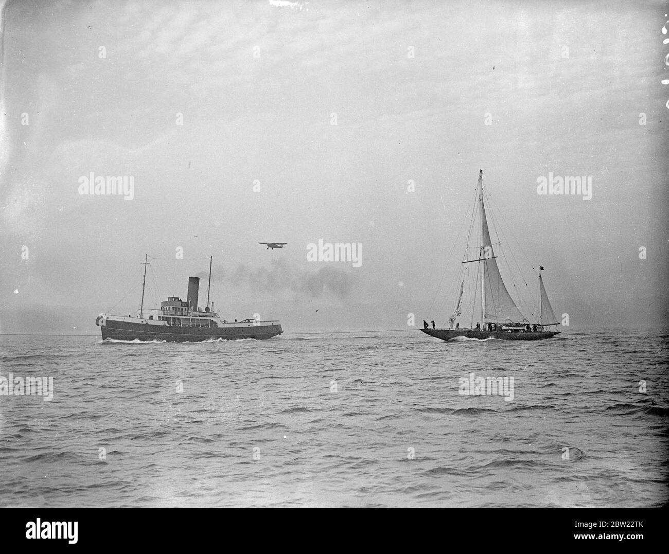 The Endeavour I being towed into the harbour. Captain Nad Heard, master of the endeavour I brought the crew and yachts safely into port in Hampshire. After their lone 2000 mile voyage across the Atlantic. 1 October 1937. Stock Photo
