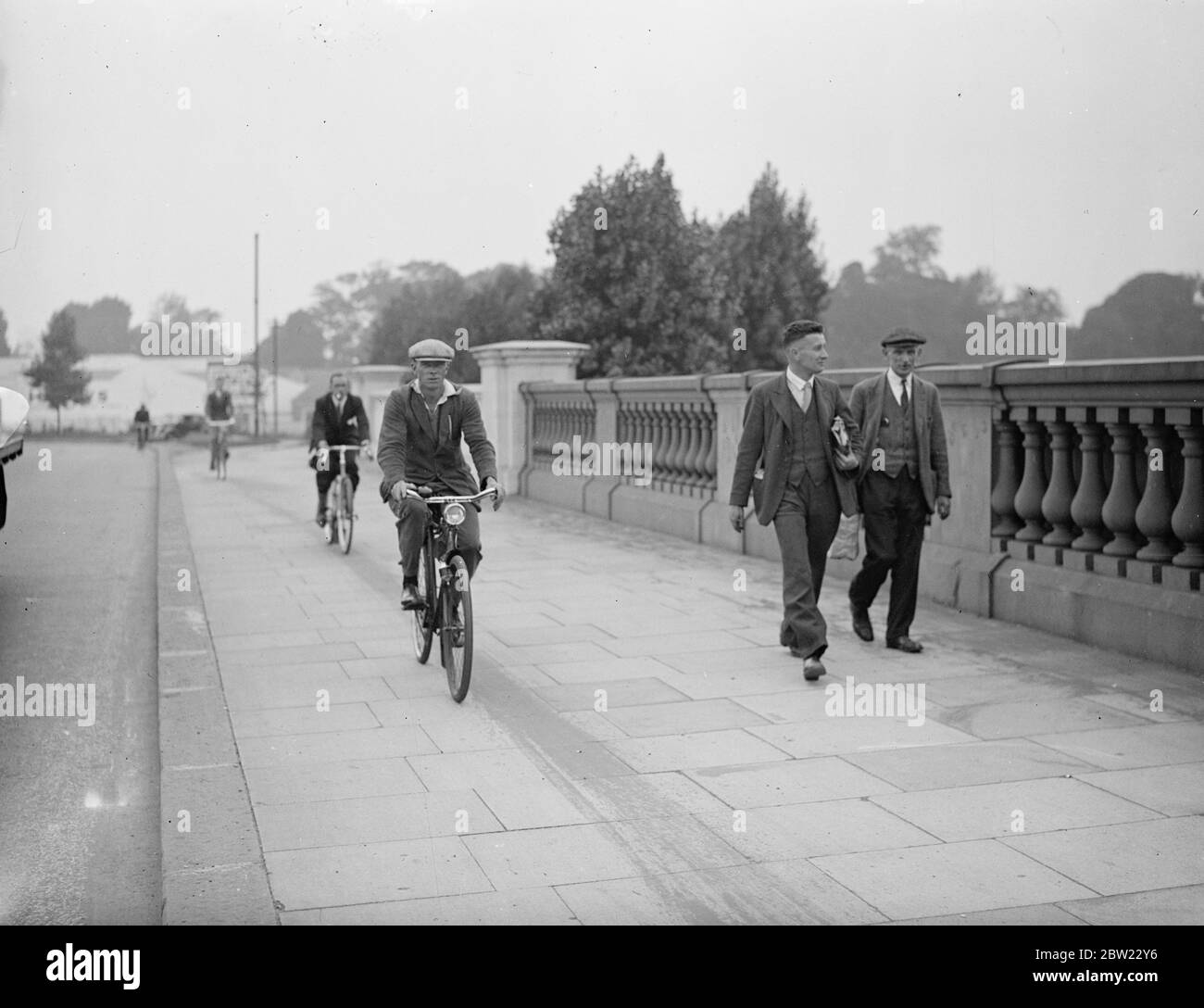 Using the pavement now with official permission. Cyclists riding alongside pedestrians on one of the bridges of the Great West Road. 31 August 1937 Stock Photo