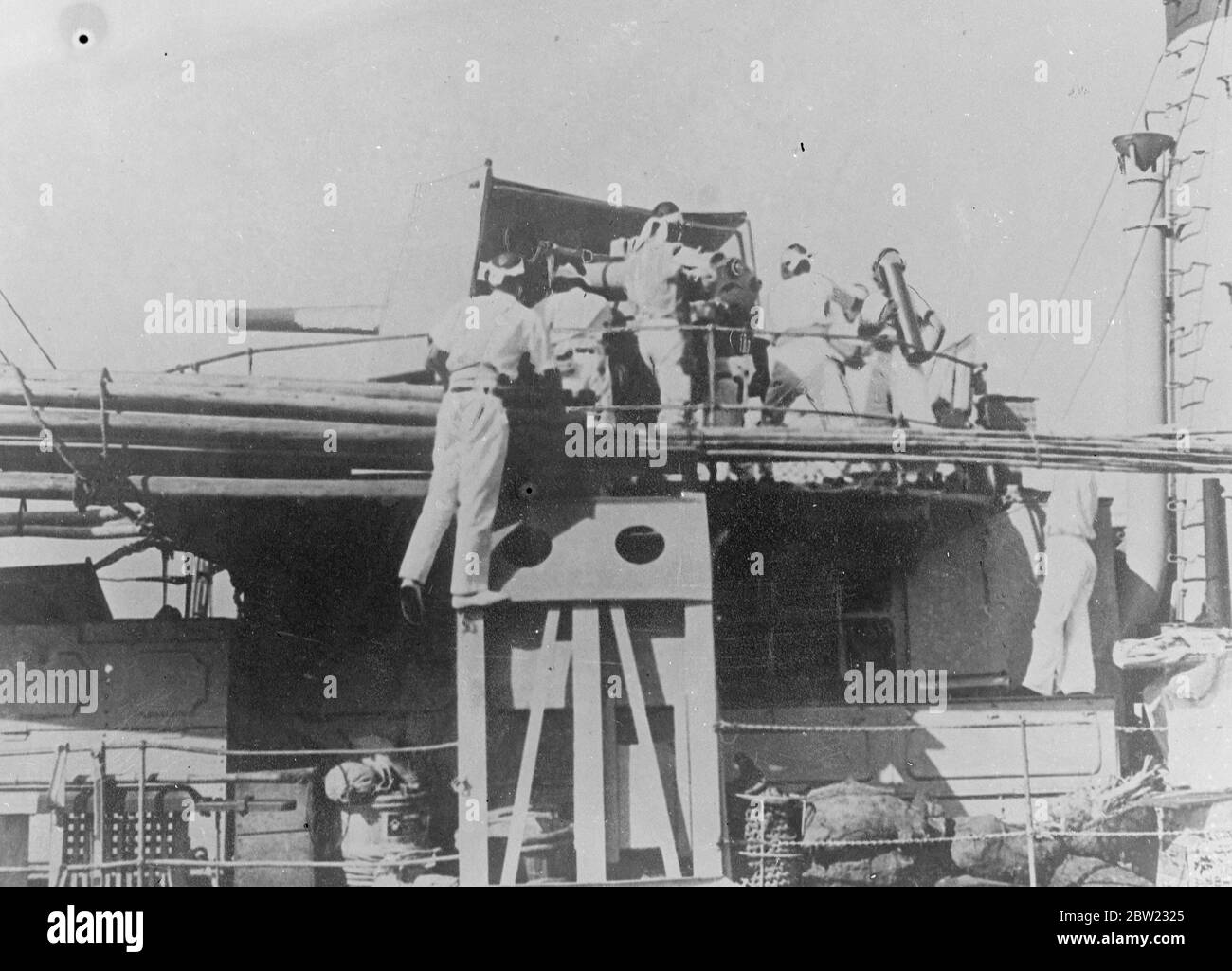 First pictures showing the Japanese Navy in action in the Chinese War. It shows a Japanese destroyer firing on the Chinese forts at Taku at the mouth of the river leading to Tientsing, North China. Sailors are loading one of the worships big guns. 1 September 1937 Stock Photo