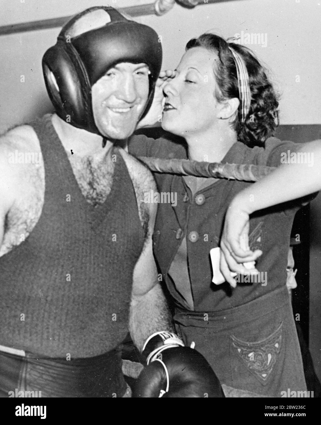 Marcel Thil, the French boxer who is recognised by the international boxing union as the world middleweight champion smilingly takes whispered advice from his wife during training at his Pompton Lakes camp, New Jersey. His training to defend his title against Fred Apostoli in New York tomorrow (Thursday). 22 September 1937 Stock Photo