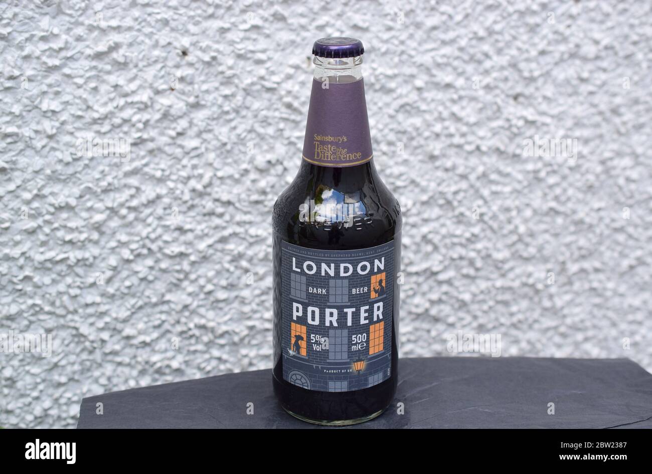 London porter full beer bottle on light textured background Stock Photo