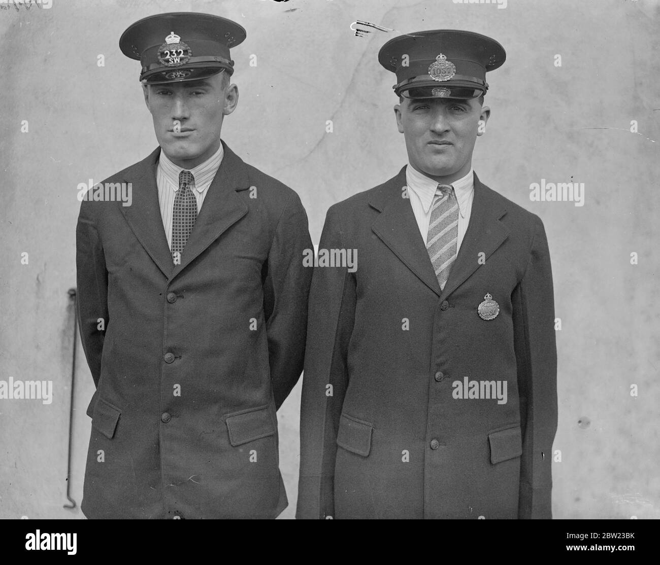 A new badge is to be issued to postmen from October 1. The badge would be worn on the cap (left) and the badge on the coat will be abolished. 1 September 1937 Stock Photo