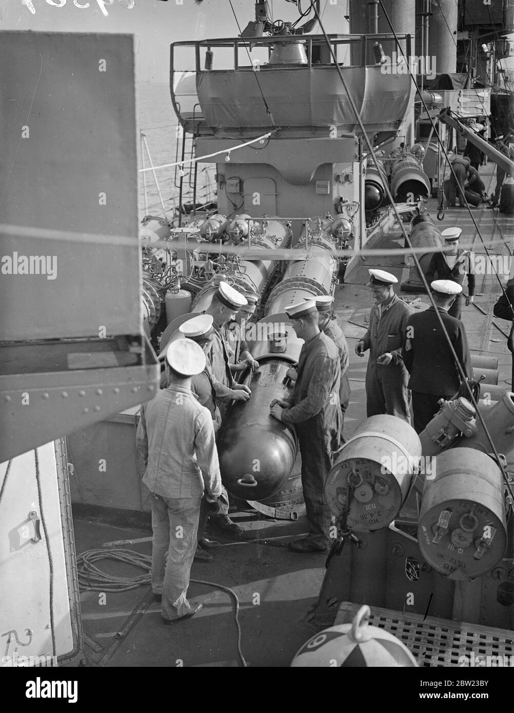 Fitting war heads on torpedos. The ships are getting ready to leave for the Mediterranean where she will join the antipiracy patrol devised at the N conference. Also leaving for the Mediterranean is the fourth destroyer Flotilla comprising of nine warships. 16 September 1937.[?] Stock Photo