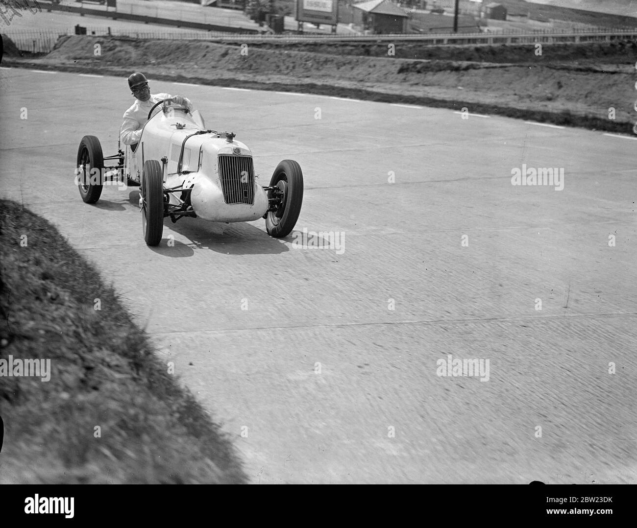 Driver , W Esplen in his supercharged MG taking the last hill on the new road track at Brooklands . 8 July 1937. Stock Photo