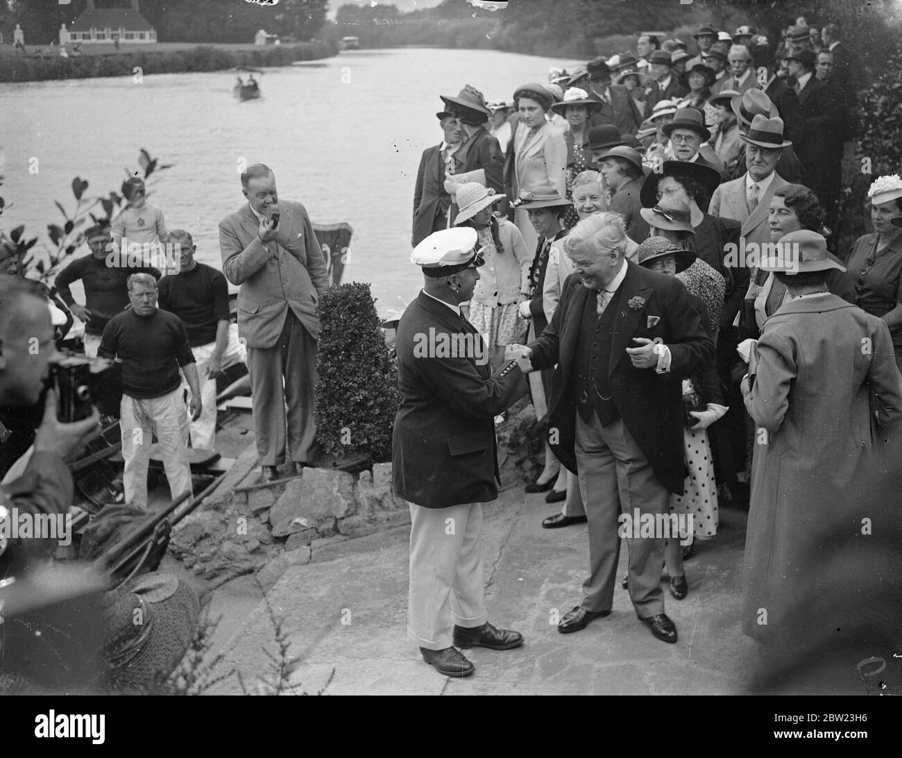 A swan upping party, one of the most unusual of social functions was held by Sir Patrick and Lady Hanham on Magna Carta Island . Sir Patrick Hanham shaking hands with Mr Fred Turk , the Kings's Swan Master. 21 July 1937 Stock Photo