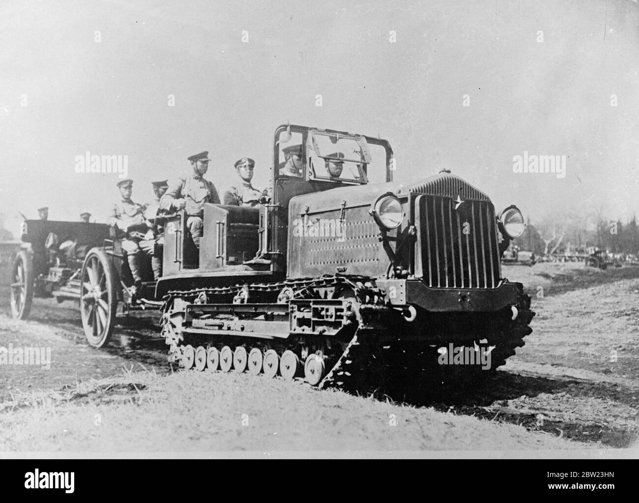 Japanese troops in half - track vehicles pulling artillery during manoeuvres. 21 July 1937 Stock Photo