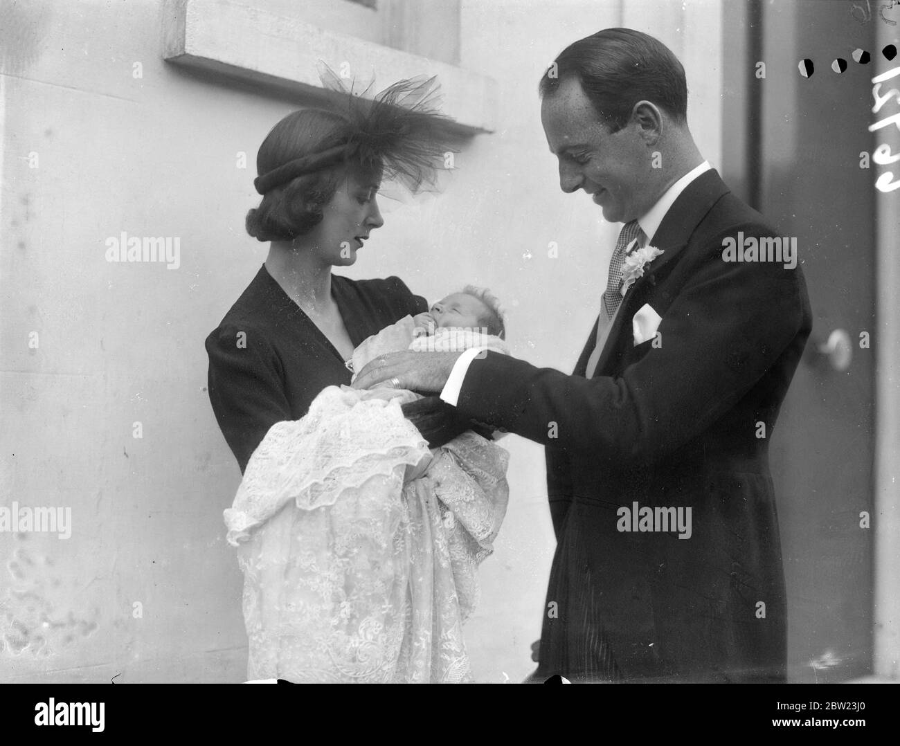 Lady Daphne Straight and Mr Whitney Straight leaving their home in Hyde Park Gardens with their baby for the christening. The baby daughter of the American racing driver was christened at St Margaret ' s Church , Westminster. She was named Camille Caroline. 21 July 1937 Stock Photo