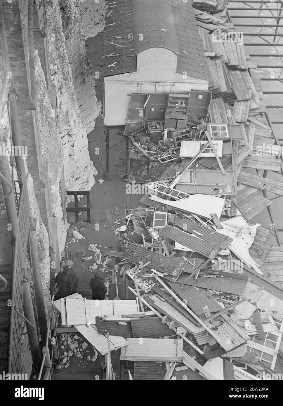 Worst Gale for 50 years , created havoc at Margate. Bathing huts and kiosks smashed. Sweeping across the South and East coasts, the worst Gale, the England has known for 50 years, left an immense trial of damage behind. Part of the promenade at Margate was torn up, the jetty smashed, kiosks and bathing huts on the beach were overturned by the winds by the wind and battered by the huge seas that smashed over the front. Photo shows, the battered mass of smashed woodwork that once formed bathing huts at Cliftonville today (Sunday) . After the Gale. 13 February 1938 Stock Photo