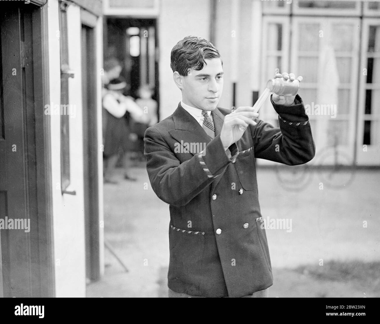 Although only 15, Jack Ralph Blanchfield, of Raynes Park, London, has matriculated with honours in all the subjects for which he sat for examination. John, only son of Mr Stanley Blanchfield, an architect, won the Merton foundation scholarship before he was 10. He is a pupil of the Rutlish Secondary School at Merton. Here's keenly interested in chemistry. Photo shows Jack Blanchfield making a chemical experiment outside his laboratory in the garden of his home. 17 October 1938 Stock Photo