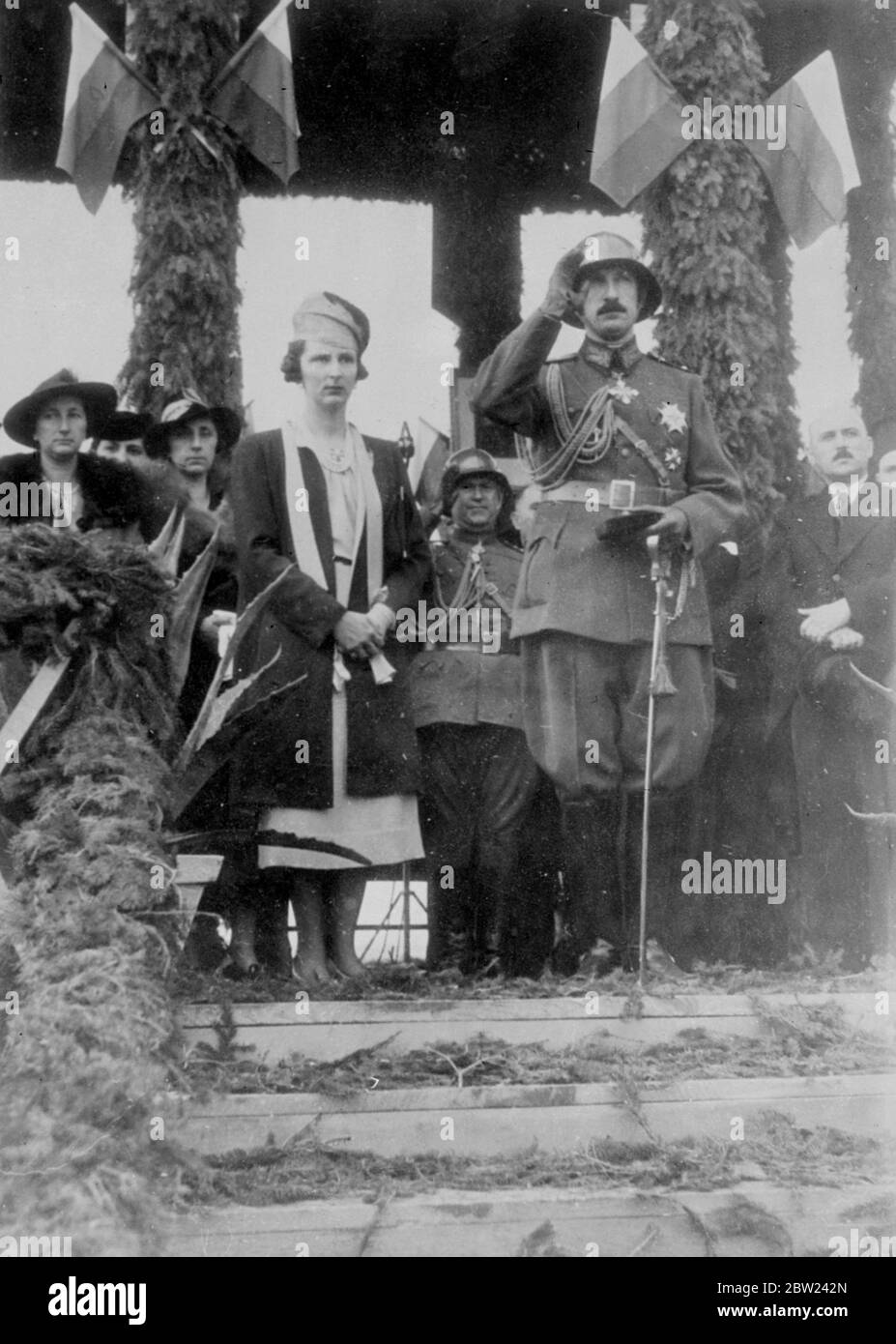 King Boris of Bulgaria, who has been attending the manoeuvres of the Bulgarian army, was accompanied by Queen Joanne when he took the salute at a military parade in celebration of the 20th anniversary of the Kings's accession. Photo shows: King Boris, in steel helmet, and Queen Joanna taking the salute at the parade. 6 October 1938 Stock Photo