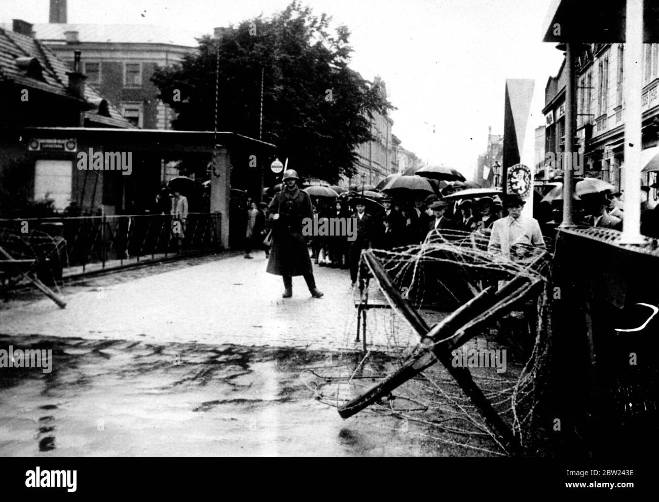 Polish forces are now in occupation of Teschen, the Polish minority district, which was ceded to Poland by Czechoslovakia in compliance with the ultimatum from Poland. The Polish demand came simultaneously with a German diplomat victory in the Sudetenland disputes. Photo shows: Citizens of Teschen waiting in the rain to greet the Polish troops when they crossed the bridge marking the old Czechoslovak Polish frontier. October 1938 Stock Photo