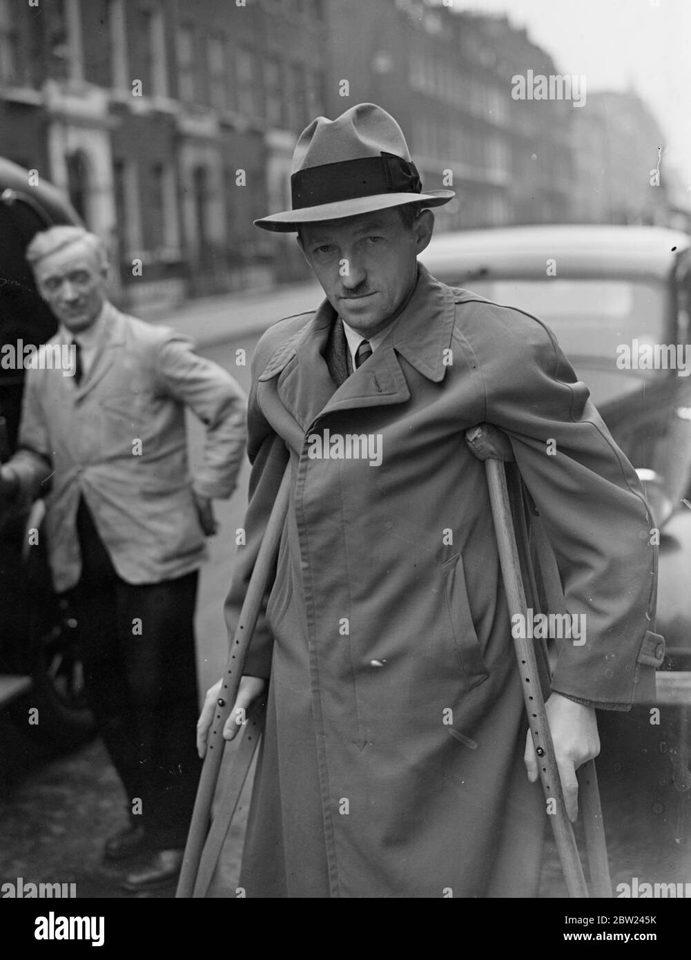 Sudeten socialist leader in London to obtain aid for refugees. Herr Jaksch, leader of the Sudeten German Socialists, is making a private visit to London and will meet Labour MPs to discuss arrangements he is trying to make to help refugees of his party, the social Democrats in Czechoslovakia. Photo shows,Herr Wenzel Jaksch, who was on crutches, leaving his hotel to visit the Czech Legation. 5 October 1938 Stock Photo