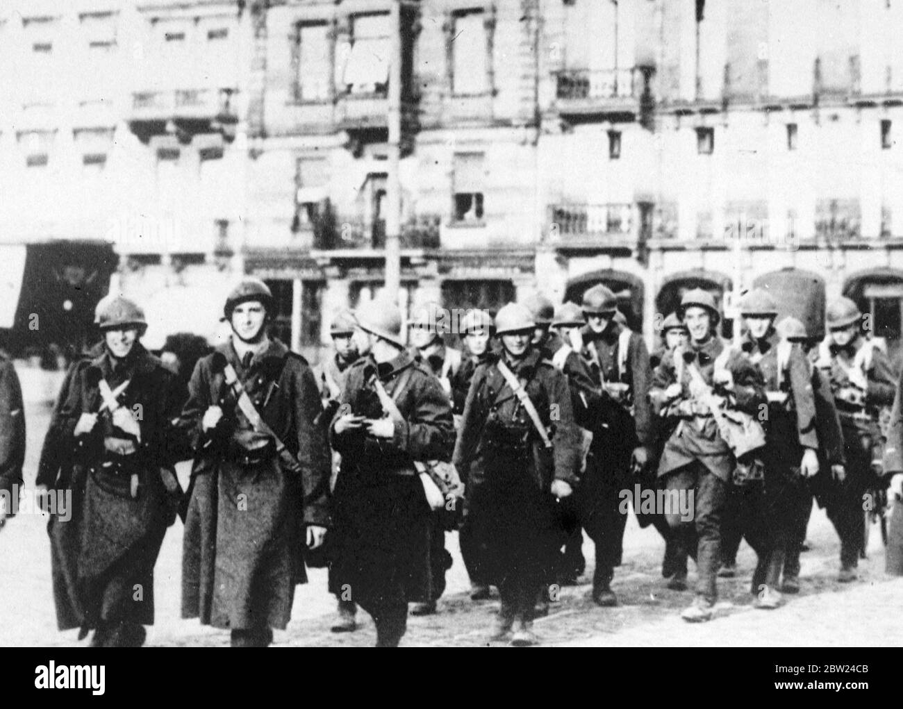France sends more troops to Maginot Line. Following the decision of the Cabinet that France will make no further concessions in the Czech crisis, troops are being sent out to the Maginot Line on the Franco German frontier. New mobilisation orders may be issued. Photo shows, French troops in steel helmets, marching through Strasberg, the strategic frontier town on the Maginot Line. 26 September 1938 Stock Photo