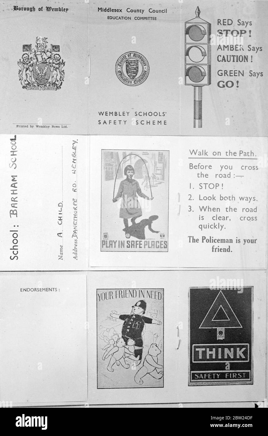 In an effort to impress safety first schoolchildren in the district, 12,000 boys and girls of Wembley, London, are being issued with road licences. Licenses contain simple safety first rules, a page for a cycle permit and a section for endorsements. Infractions of the rules results in endorsement by school prefects or teachers. Originators of the ideas is Miss M E Hill, headmistress of the Barham Road School, Wembley. Photo shows: The road licence issued to the Wembley school children. 14 September 1938 Stock Photo