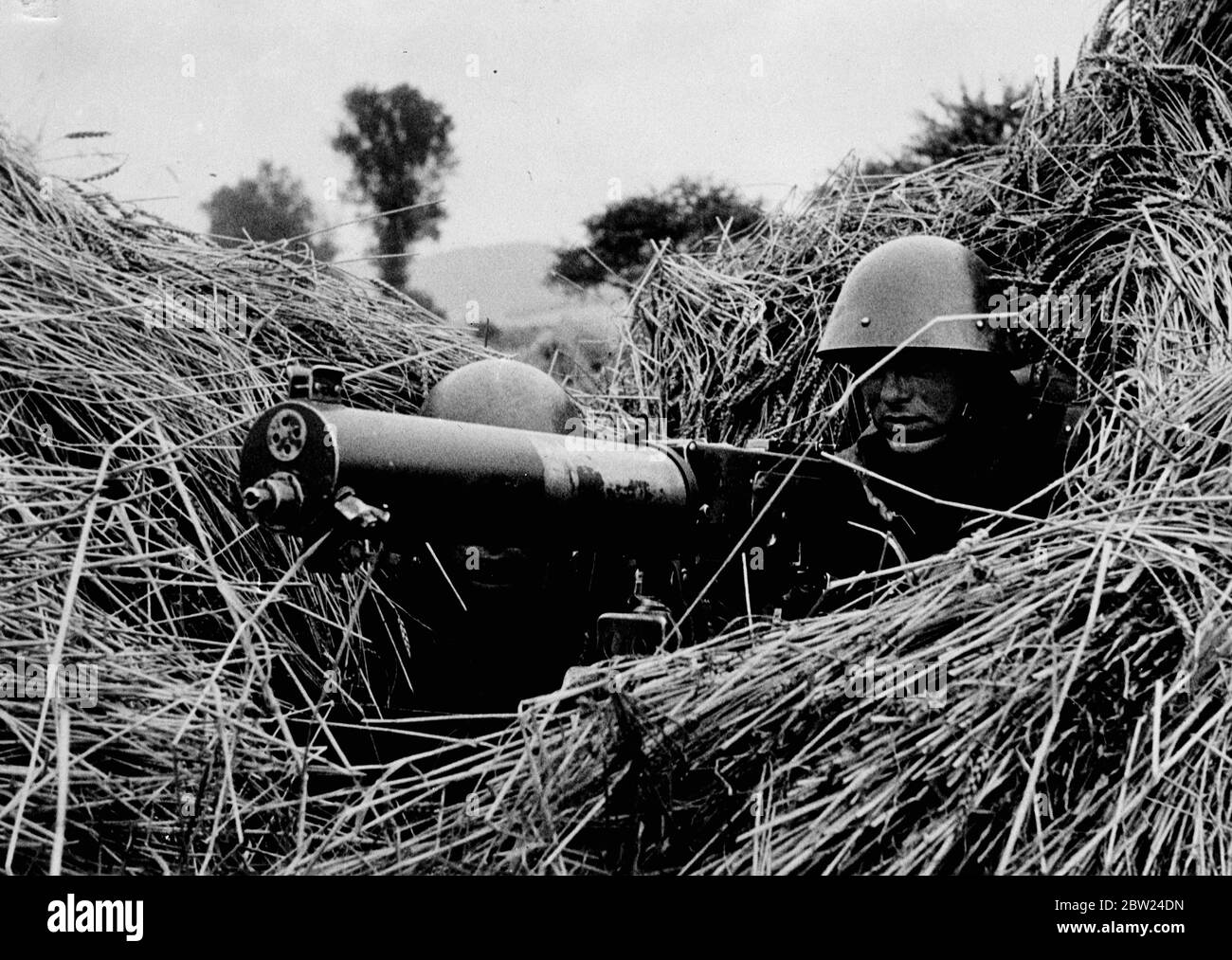 Czech Army machine gunner in a hidden emplacement in a field. issued early September 1938 Stock Photo