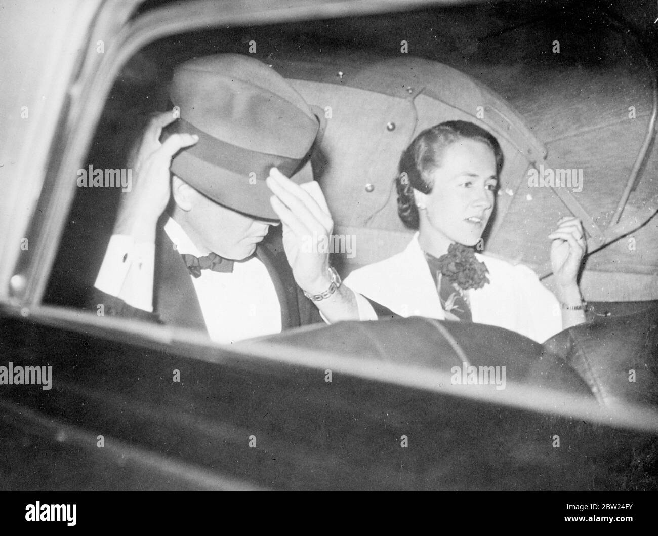 Colonel Charles A Lindbergh tilting his hat in an effort to conceal his face as, with Mrs Lindbergh, he drove away from the hotel Crillon in Paris to attend a party. , Colonel Lindbergh has reportedly visited Russia, Poland and Central Europe. 10 September 1938 Stock Photo