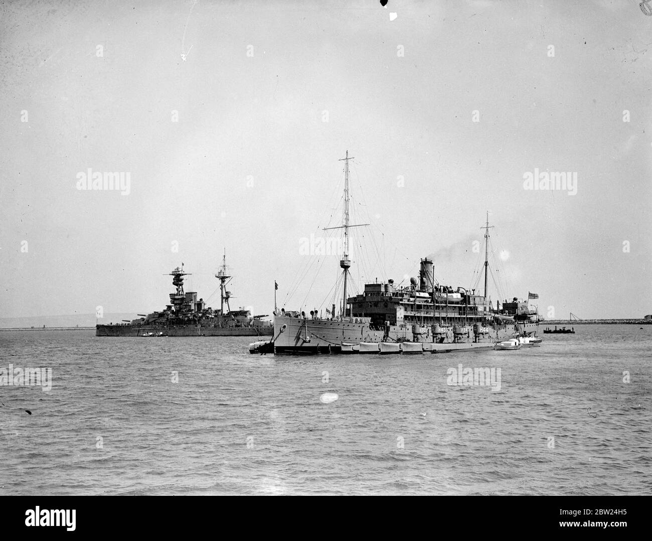 Swift measures have been taken by the British Admiralty owing to the Sudeten-German-Czech crisis which is expected to reach a climax this weekend. Although most of the home fleet is concentrated at Invergordon, submarine flotillas are standing by Portland and the First Minesweeping Flotilla is being brought up to full complement while four minelaying destroyers are to be placed in full commission from reserve. Photo shows: The depot ship Titania and four submarines of the sixth Flotilla standing by at Portland. 11 September 1938 Stock Photo