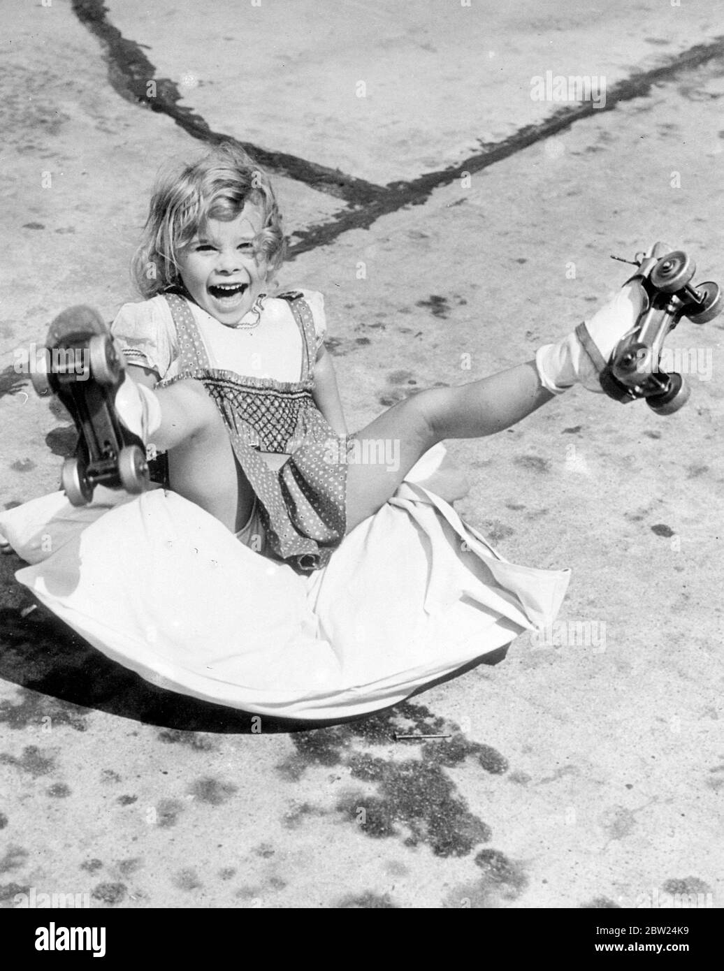 First 'steps' on skates by new child film actress. Many people have painful memories of their first acquaintances with roller skates. Perhaps they never realised how amusing their earliest efforts appeared to bystanders!. These pictures were made when little Janet Chapman, new six-year-old film actress, now appearing in Warner Brothers 'Three Girls on Broadway' in Hollywood, went through the same exciting ordeal. The skates were given to her by John Farrow, the film director. Janet's sturdy little legs did the rest!. Photo shows, Janet makes another rapid descent, but she can afford to laugh t Stock Photo
