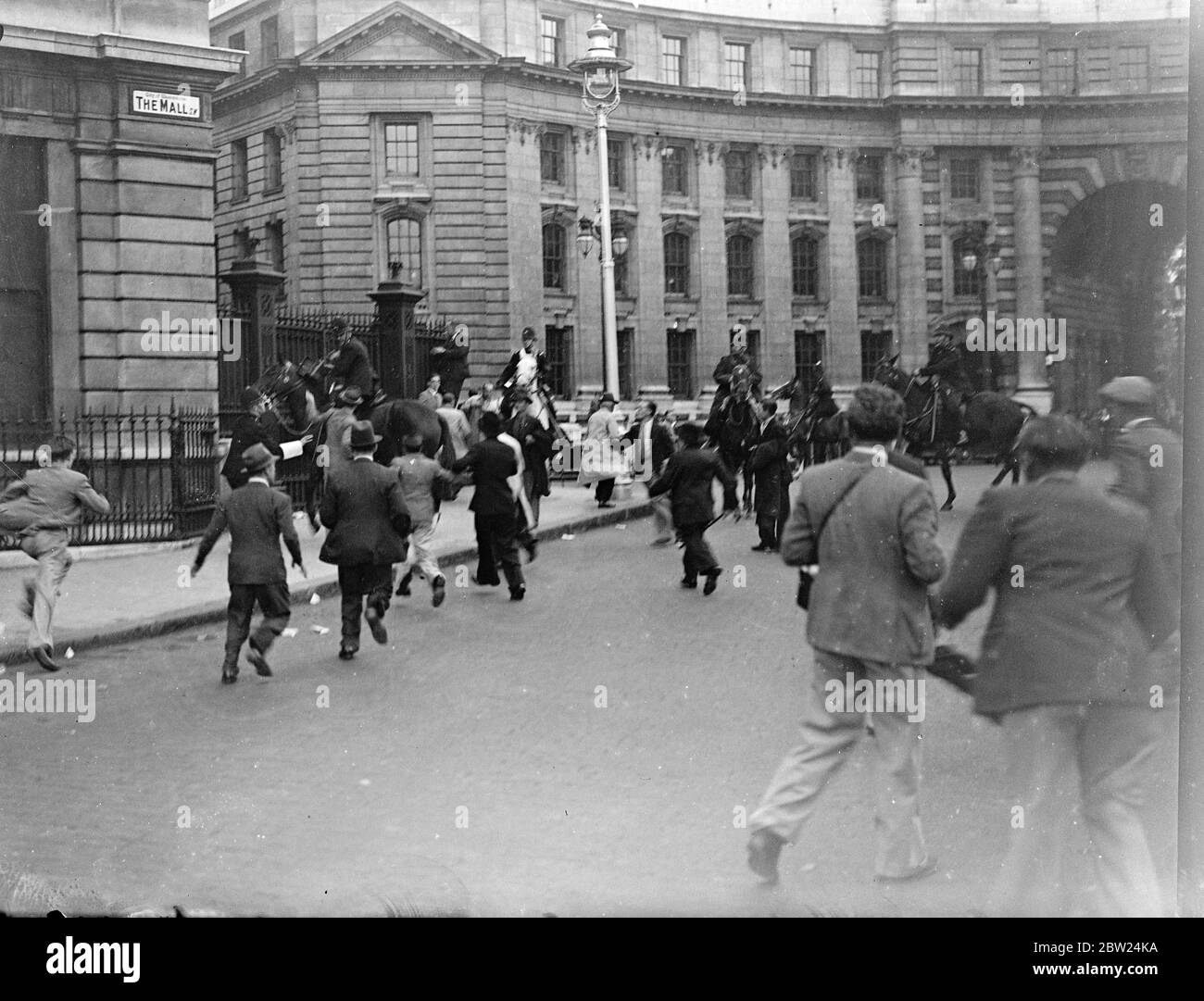 Following peace demonstrations in Trafalgar Square, riots broke out in Whitehall and The Mall when members of the crowd tried to break through police cordon to Downing Street. Mounted and feet police charged the crowds repeatedly. Photo shows: Members of the crowd rushing mountain police in The Mall. 18 September 1938 Stock Photo