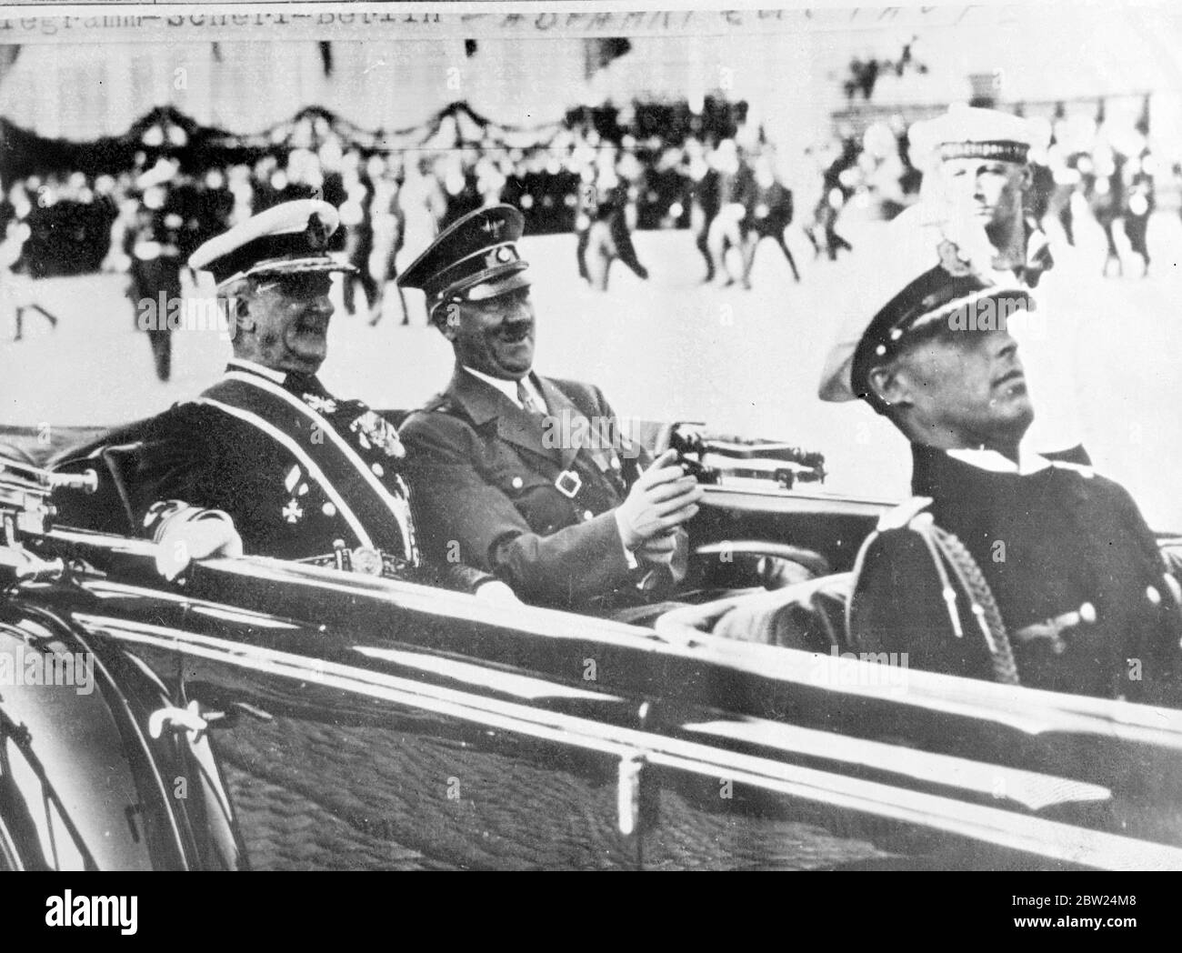 Horthy drives with Hitler in Kiev. Admiral Horthy, the Hungarian Regent, who is on an official visit to Germany, drove with Chancellor Hitler through the decorated streets of Kiel to the Germania shipyard, where the Adml's wife christened Germany's latest 10,000 ton battleship, 'the 'Prince Eugene'. Photo shows, Adml Horthy (left) and Chancellor Hitler, smiling as they drove through Kiel. 22 August 1938 Stock Photo