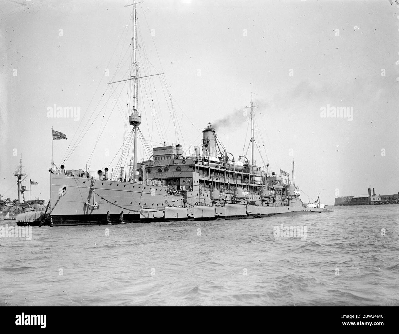 Swift measures have been taken by the British Admiralty owing to the Sudeten-German-Czech crisis which is expected to reach a climax this weekend. Although most of the home fleet is concentrated at Invergordon, submarine flotillas are standing by Portland and the First Minesweeping Flotilla is being brought up to full complement while four minelaying destroyers are to be placed in full commission from reserve. Photo shows: The depo ship Titania and four submarines of the sixth Flotilla standing by at Portland. 11 September 1938 Stock Photo