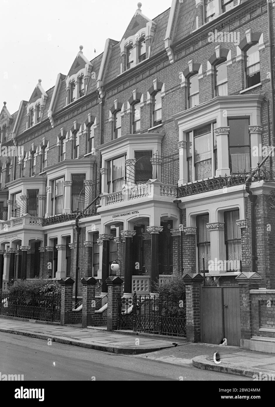 Cook runs London hotel on 7p 'capital'. For five days, a woman cook, for chambermaids, two waitresses and a pantry boy had been running the Cedars Mansions Hotel, consisting of four adjoining houses in Gunterstone Road, West Kensington. Mr Arthur Wells, the proprietor, and his wife, left the hotel last Sunday and later a telephone message was received, saying that Mr and Mrs Wells were not coming back. There was only 7d, in the office and hardly any coal. The gas was cut off on Tuesday. There were 30 guests in the hotel, who had to eat out. Now there are only five and they are making arrangeme Stock Photo