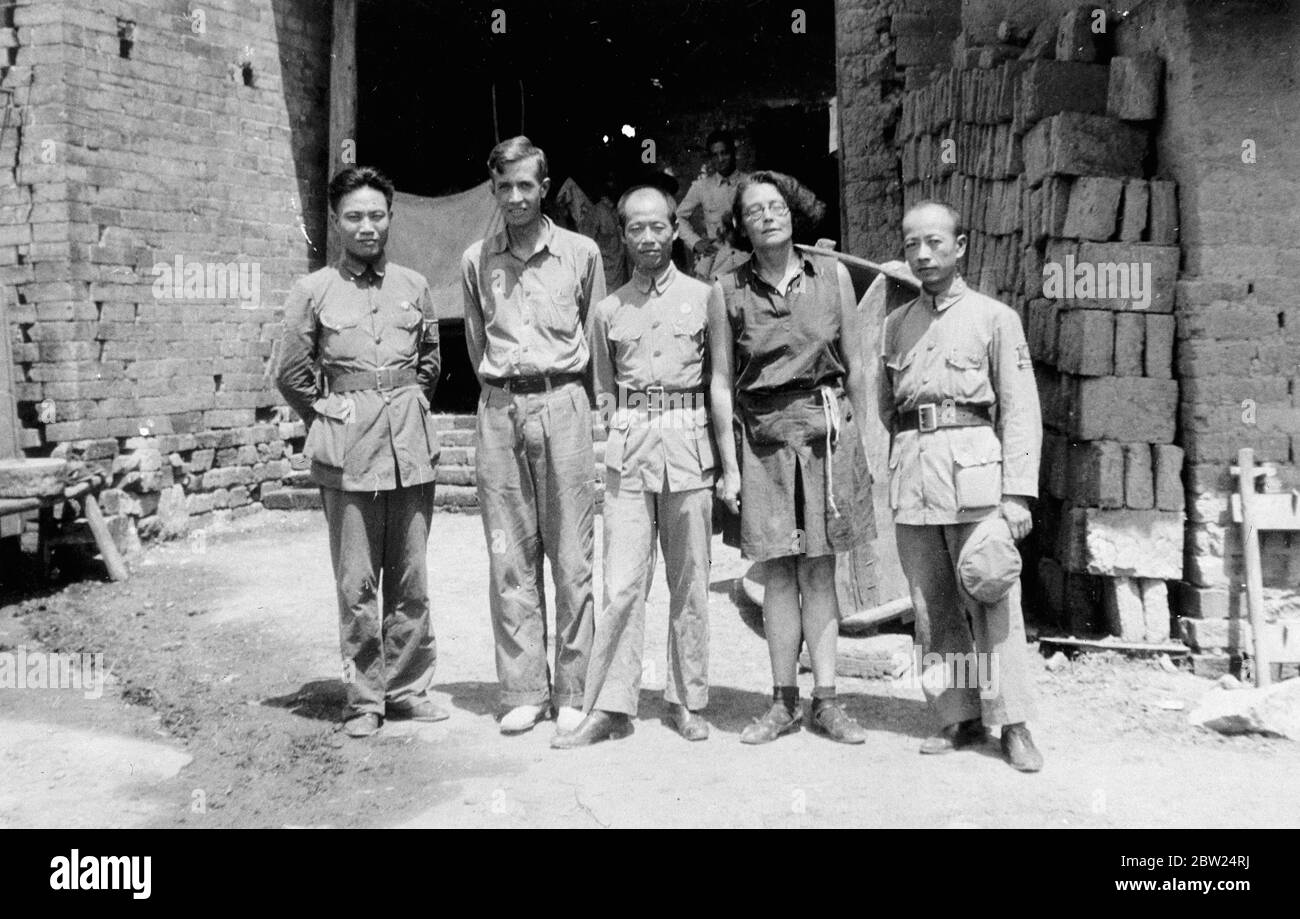 The Cantonese General Li Han-Yuen (centre), who for more than a month held back the Japanese 13 miles south of the Kiukiang on the road to Hankow, seat of the Chinese government. This picture was made at his field headquarters near Shaho. With him are Miss Freda Utley, author of Japan's Fleet of Clay. Extreme right is the General's chief of staff and extreme left, Colonel Mok, the French-speaking aide-de-camp. On the General's right is Robert W Murphey, American newspaper correspondent. Miss Utley is also sitting as a correspondent for a London newspaper. September 1938 Stock Photo