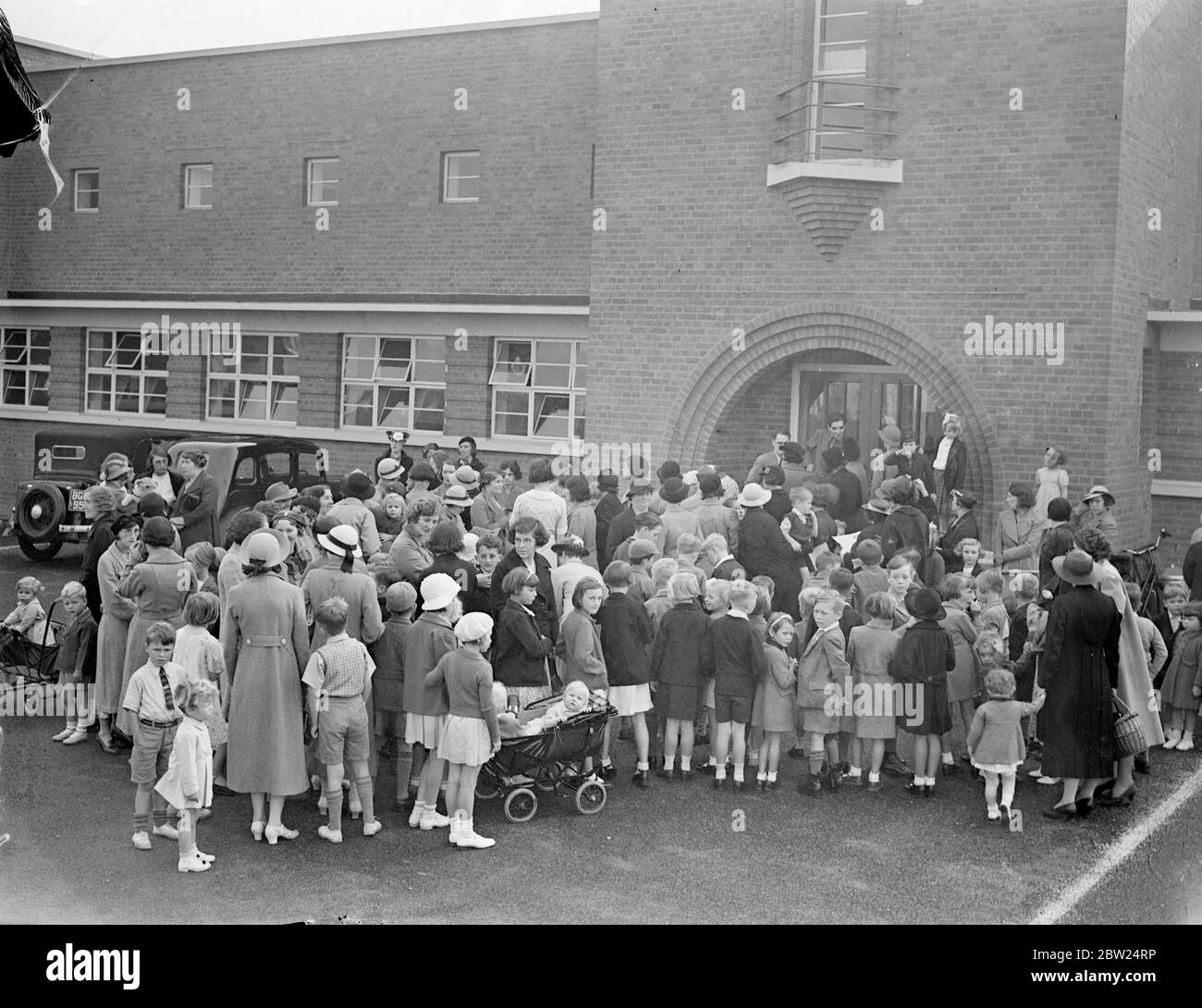 120 Southall children in 'school strike'. Although the new term was due to begin, there was no school for 120 children living at the Lady Margaret estate, Southall, Middlesex, their parents having decided on a 'school strike' as a protest against transference of all pupils between seven and 11 years old, from North Road school to Tudor Road school. This change means a walk of more than a quarter of an hour instead of about eight minutes. Mothers took their children to the new Lady Margaret School on the estate and demanded admission for the children., Photo shows, mothers and children locked o Stock Photo