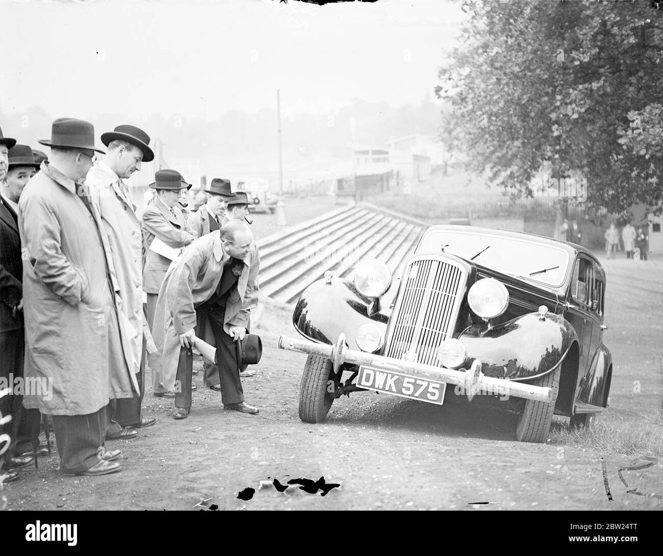 New 'car for the world' demonstrated on Crystal Palace track. The new Humber Super Snipe, a car which has been specially built to meet conditions all over the world, was demonstrated to a gathering of experts on the Crystal Palace road racing track. The car is said to fill a gap in British car manufacturers because it is equally suitable for drivers at home or abroad. Photo shows, spectators watching the new Humber Super Snipe climbing a one in four gradient in top gear. From a standing start in top gear. Centre is W E Rootes of the Humber Company. 8 September 1938 Stock Photo