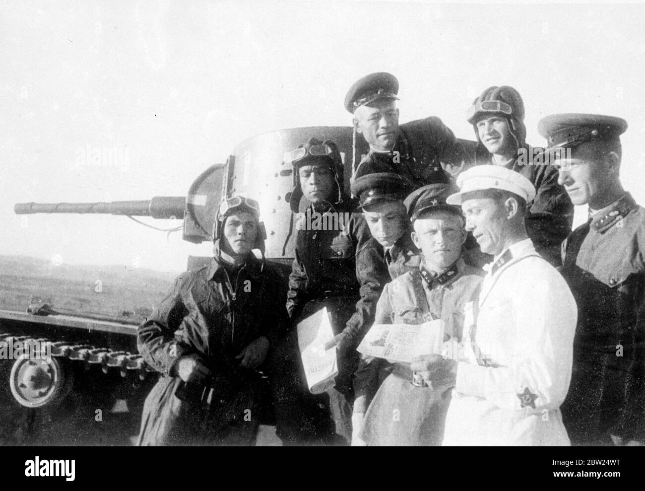 First pictures from the Soviet - Manchukuo front. This picture is the first to arrive from the Soviet Manchukuo front, where there has been severe fighting between the Soviet and Japanese forces, and shows a Soviet tank commander reading to as men, a newspaper account of the armistice agreed upon by the two counties. 21 August 1938 Stock Photo