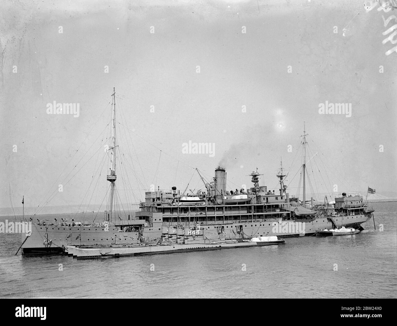 Swift measures have been taken by the British Admiralty owing to the Sudeten-German-Czech crisis which is expected to reach a climax this weekend. Although most of the home fleet is concentrated at Invergordon, submarine flotillas are standing by Portland and the First Minesweeping Flotilla is being brought up to full complement while four minelaying destroyers are to be placed in full commission from reserve. Photo shows: The depot ship Titania and four submarines of the sixth Flotilla standing by at Portland. 11 September 1938 Stock Photo