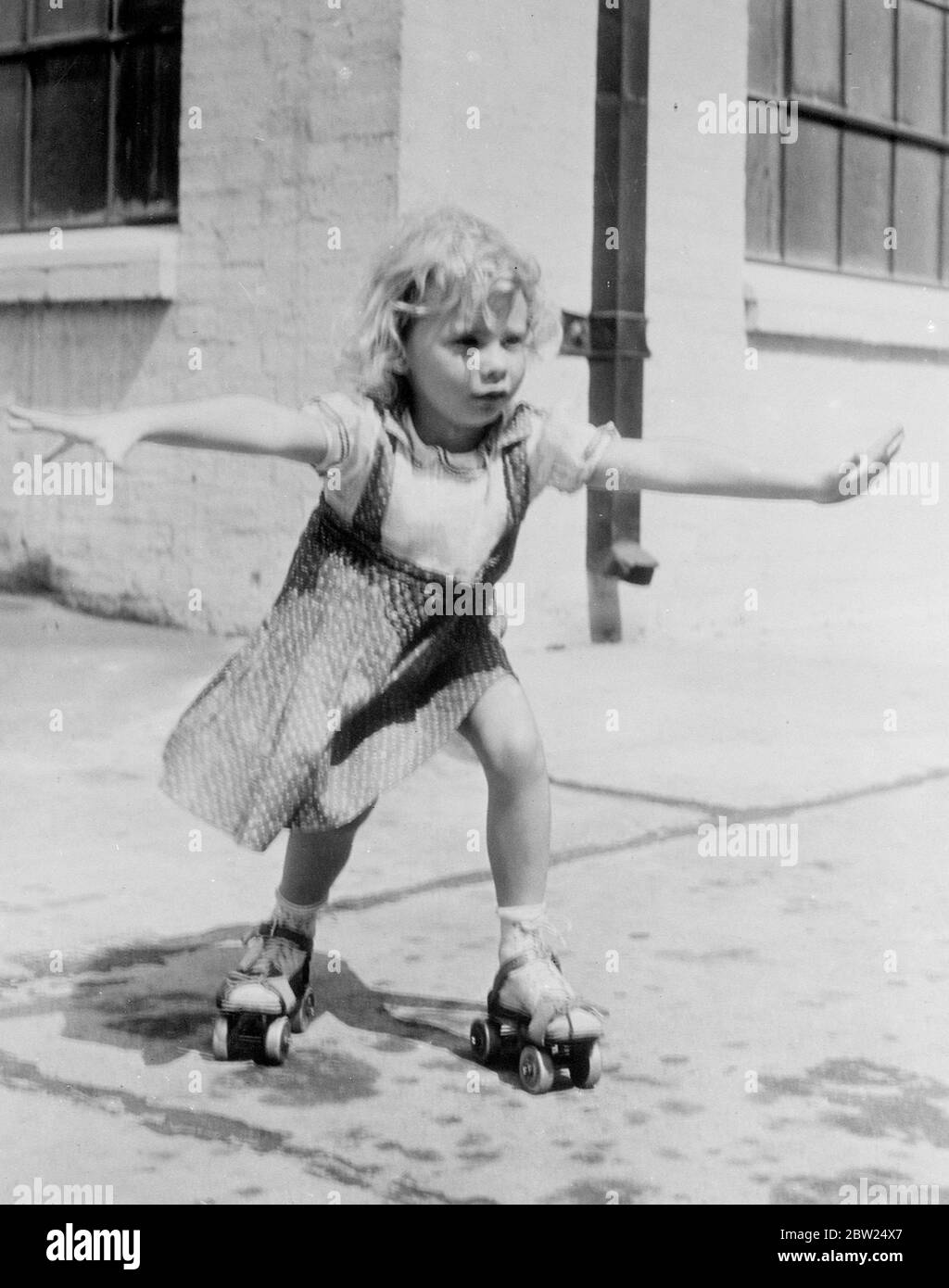 First 'steps' on skates by new child film actress. Many people have painful memories of their first acquaintances with roller skates. Perhaps they never realised how amusing their earliest efforts appeared to bystanders!. These pictures were made when little Janet Chapman, new six-year-old film actress, now appearing in Warner Brothers 'Three Girls on Broadway' in Hollywood, went through the same exciting ordeal. The skates were given to her by John Farrow, the film director. Janet's sturdy little legs did the rest!. Photo shows, Janet makes an optimistic start. Stock Photo