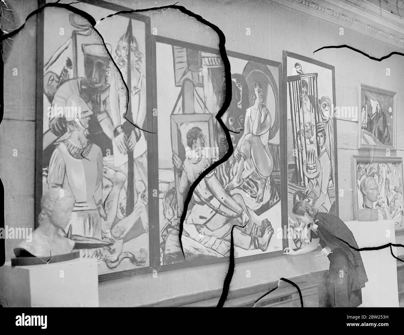 14 Ft expressionist picture on view at 'Degenerate' Art Show in London. Depicts 'Temptations' The priveat view of the Exhibition of 20 century Gorman Art (rejected by the German Nazis as 'degenerate') took place at the New Burlington Galleriers, Burlington Gardens. The Exhibition is to be opened by Mr Augustus John tomorrow (Thursday). The exhibition includes works by all the German artists, most of them now in exile, whom Hitler pilloried in the famous 'degenerate Art' exhibited at Munich last year. Photo shows, Mme Irmgard Burchard, honorary organiser of the Exhibition, arranging the work wh Stock Photo