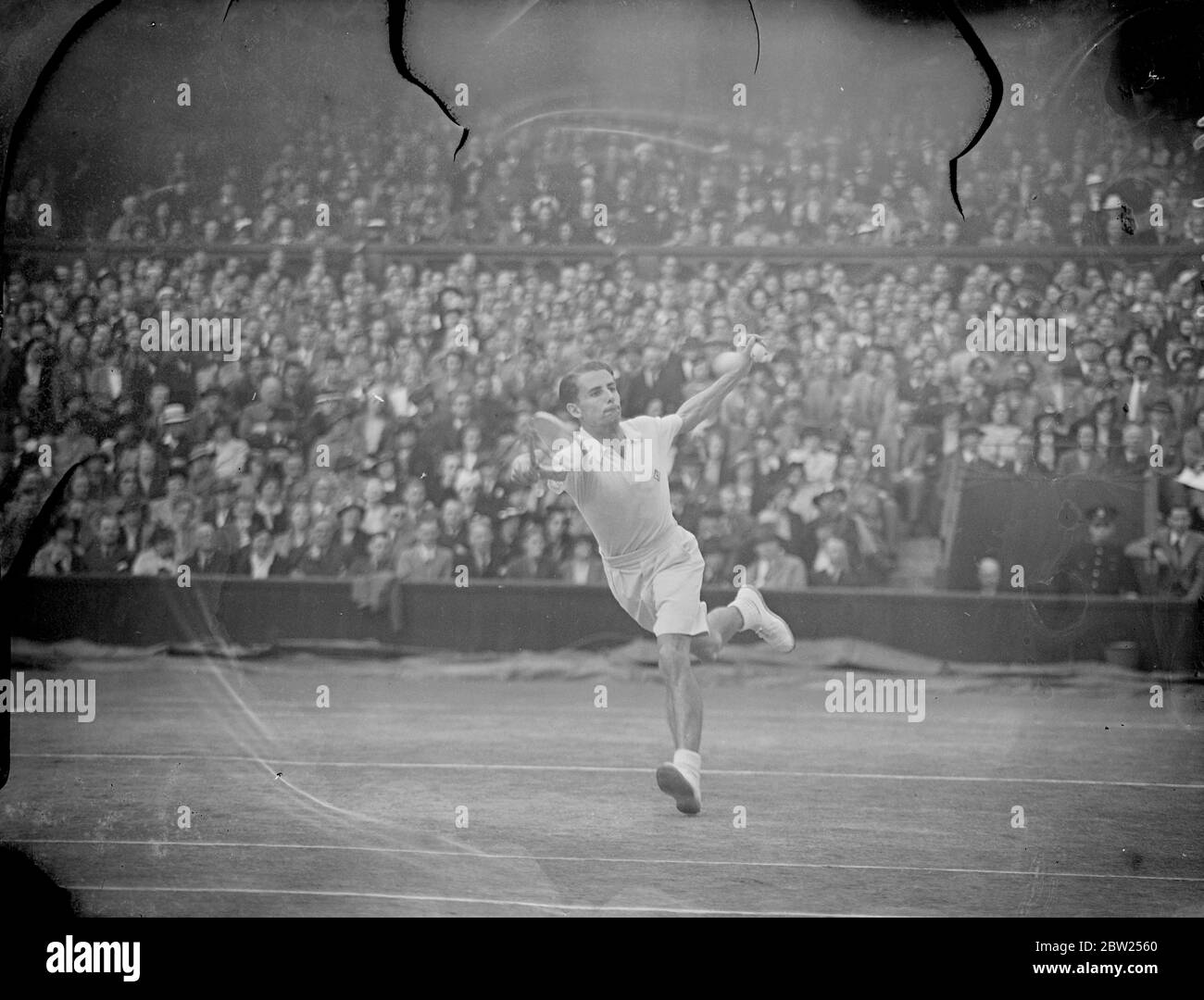 Budge beats Austin to retain Wimbledon title. Donald Budge, the American beat H W (Bunny) Austin in three sets 6-1, 6-0, 6-3 to retain the men's singles title at Wimbledon, London. Photo shows, Bunny Austin in play. 1 July 1938 Stock Photo