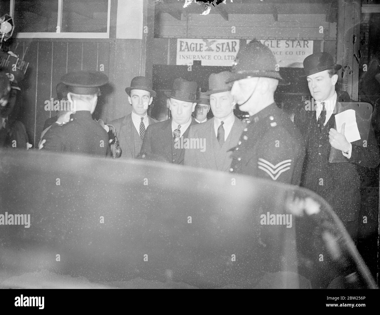Count Haugwitz Reventlow arrested at Victoria Station. Count Kurt Haugwitz Reventlow, husband of the former Barbara Hutton, arrived at Victoria Station, London, from paris, to appear at Bow Street. He was escorted from Dover by officers of the Special brranch at Scotland yard. last week, following runours of Kidnap threats to their son, lance, Countess Haugwitz Reventlow went to Bow Street. A warrant was issued for the arrest of the Count. Photo shows, Count Kurt haugwitz Reventlow under arrest at Victoria Station. 1 July 1938 Stock Photo