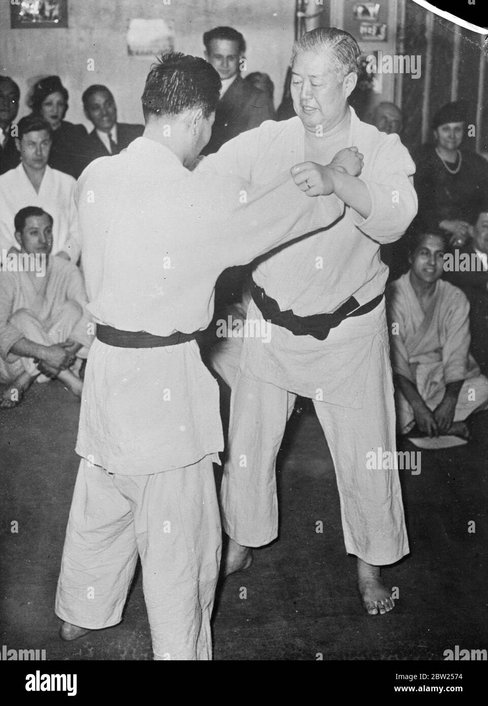 When the An Ambassador gets rough!. Wrestler from the diplomatic corps. Mr Sugimura, Japanese Ambassador to Paris, demonstrated his prowess as a Jujitsu wrestler, when he twice through Professor Kawaishi, founder of the Franco Japanese jujitsu club, at a meeting of the club in Paris. Mr Sugimura is now over 50 years of age. He is a former university champion at jujitsu and is holder of the black belt, denoting a high rank as a wrestler. Photo shows, Mr Sugimura (facing camera) getting to grips with his opponent. 31 January 1938 Stock Photo