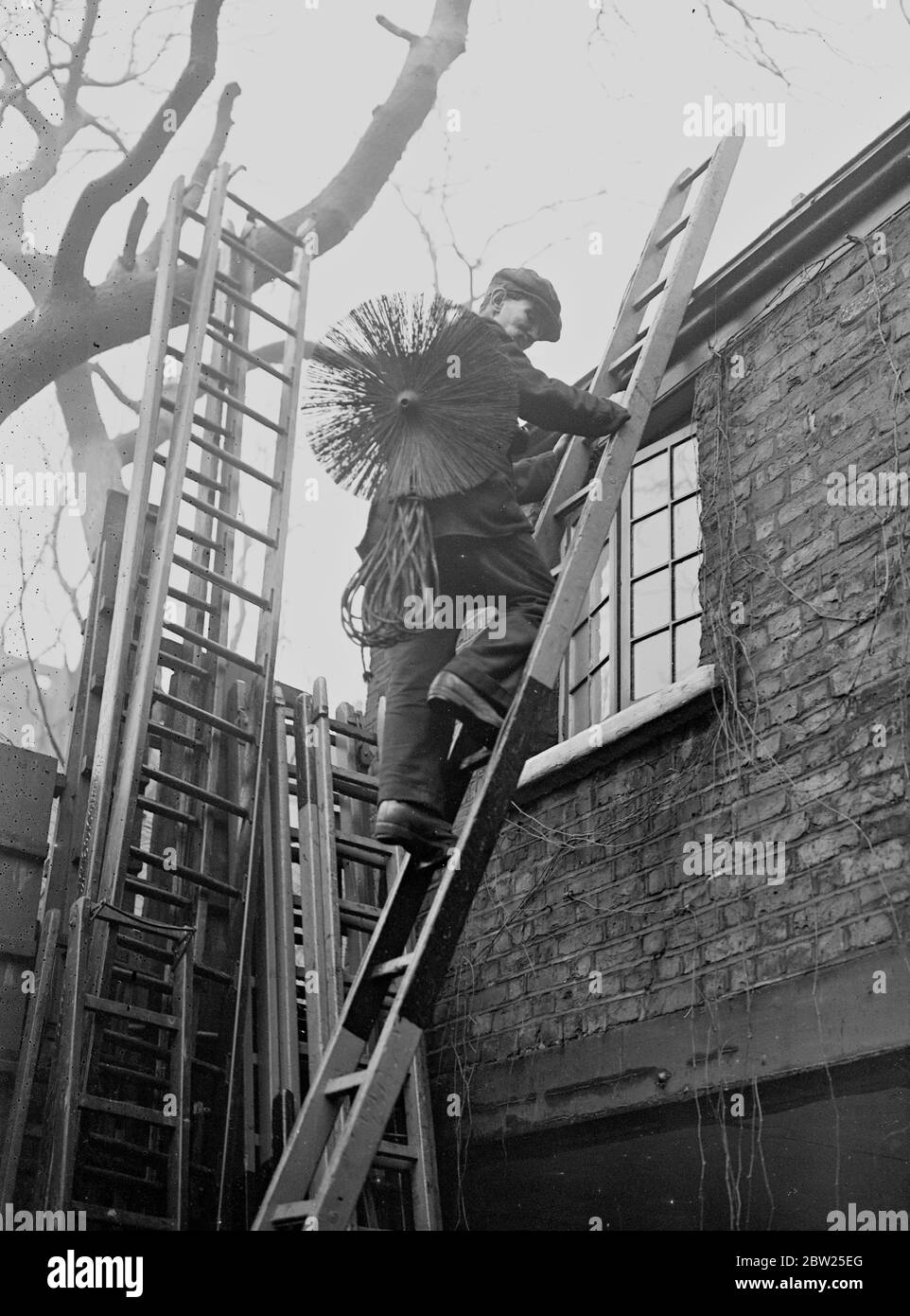 A Day in the life of a chimney sweep. A chimney sweep climbs to the roof. Stock Photo
